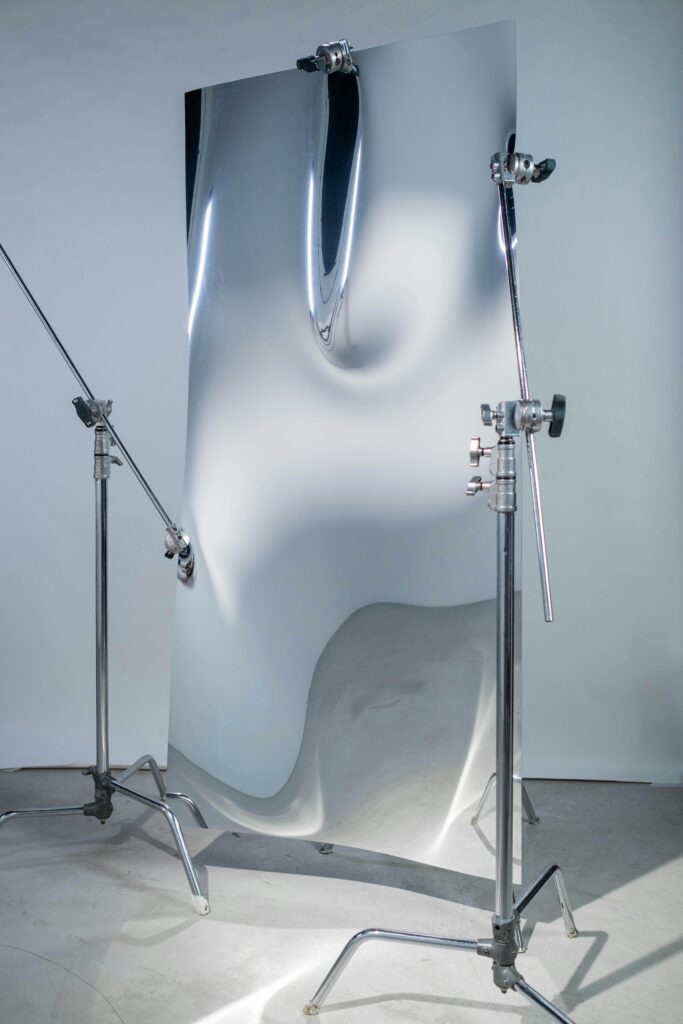 Elegant abstract distortion on a reflective metal sheet, studio setting.